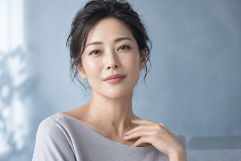 Illustrative portrait of an adult Asian woman with natural skin texture in soft studio light